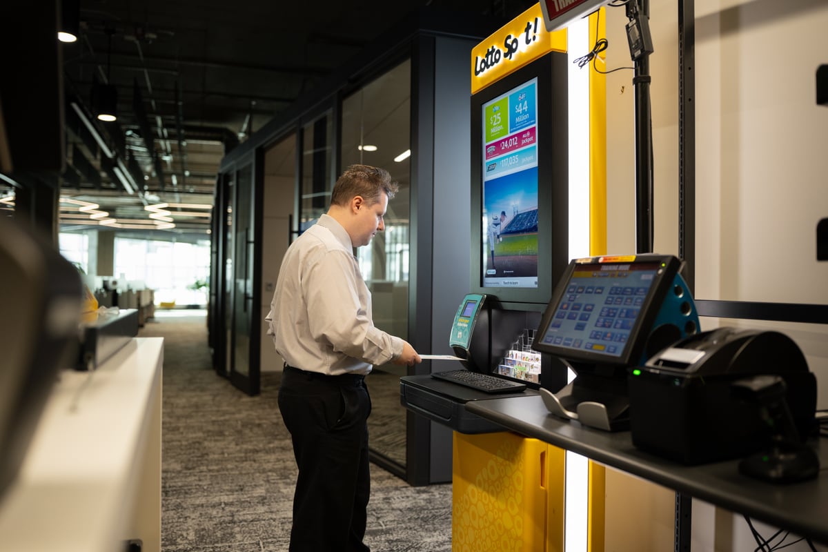 Customer using a self-serve kiosk in a Winnipeg branch, photographed on location