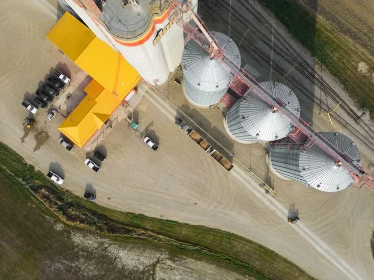 Aerial drone photograph of grain bins and an agricultural terminal in rural Manitoba