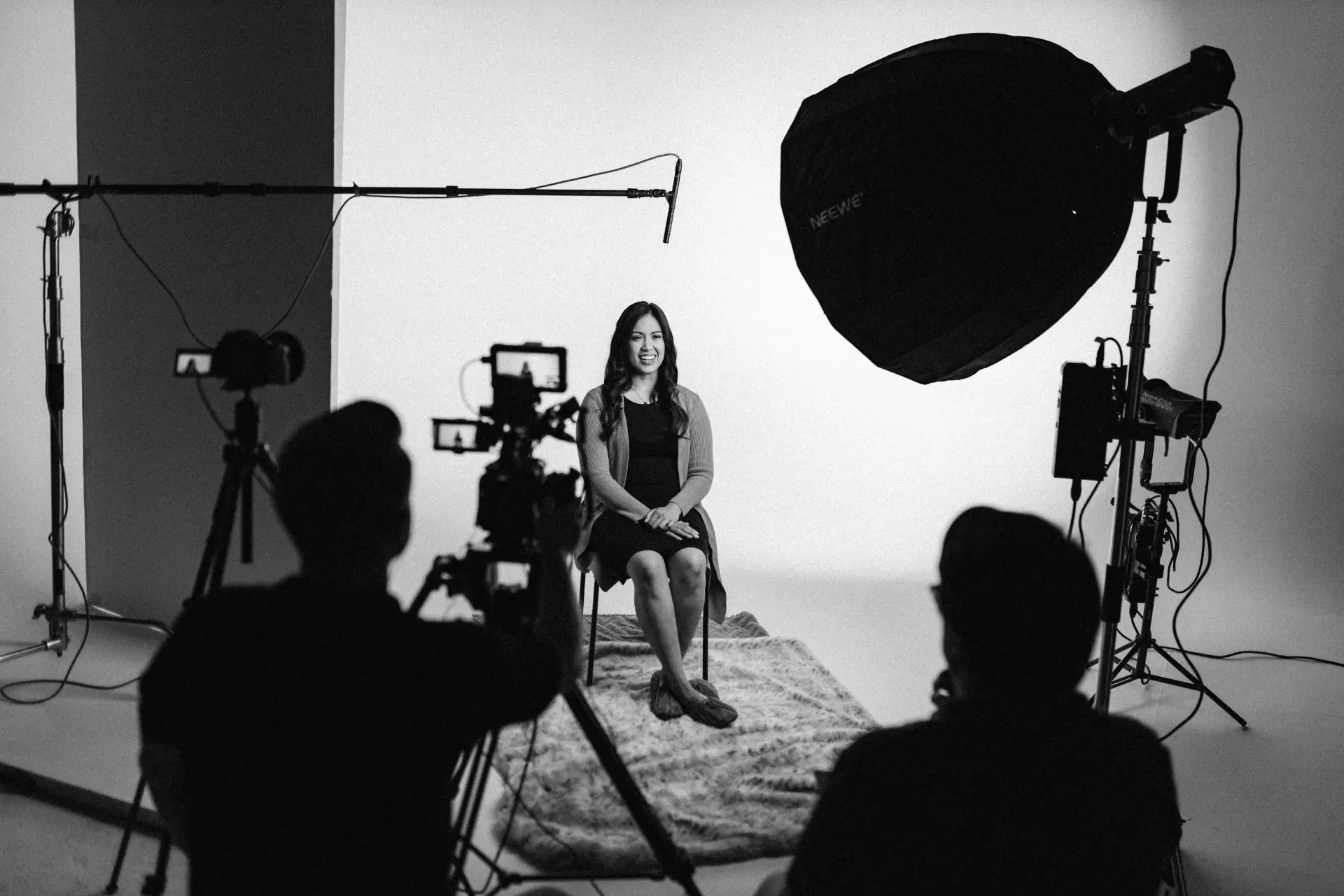 Vanguard Creative crew filming a seated interview on a studio cyclorama in Winnipeg